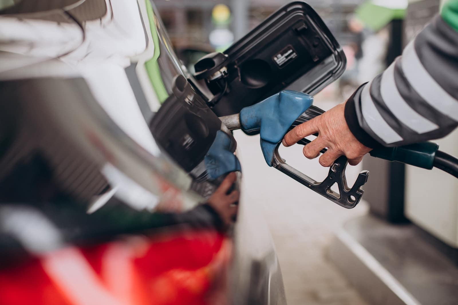 Hand holding a fuel nozzle at a JN Energy pump