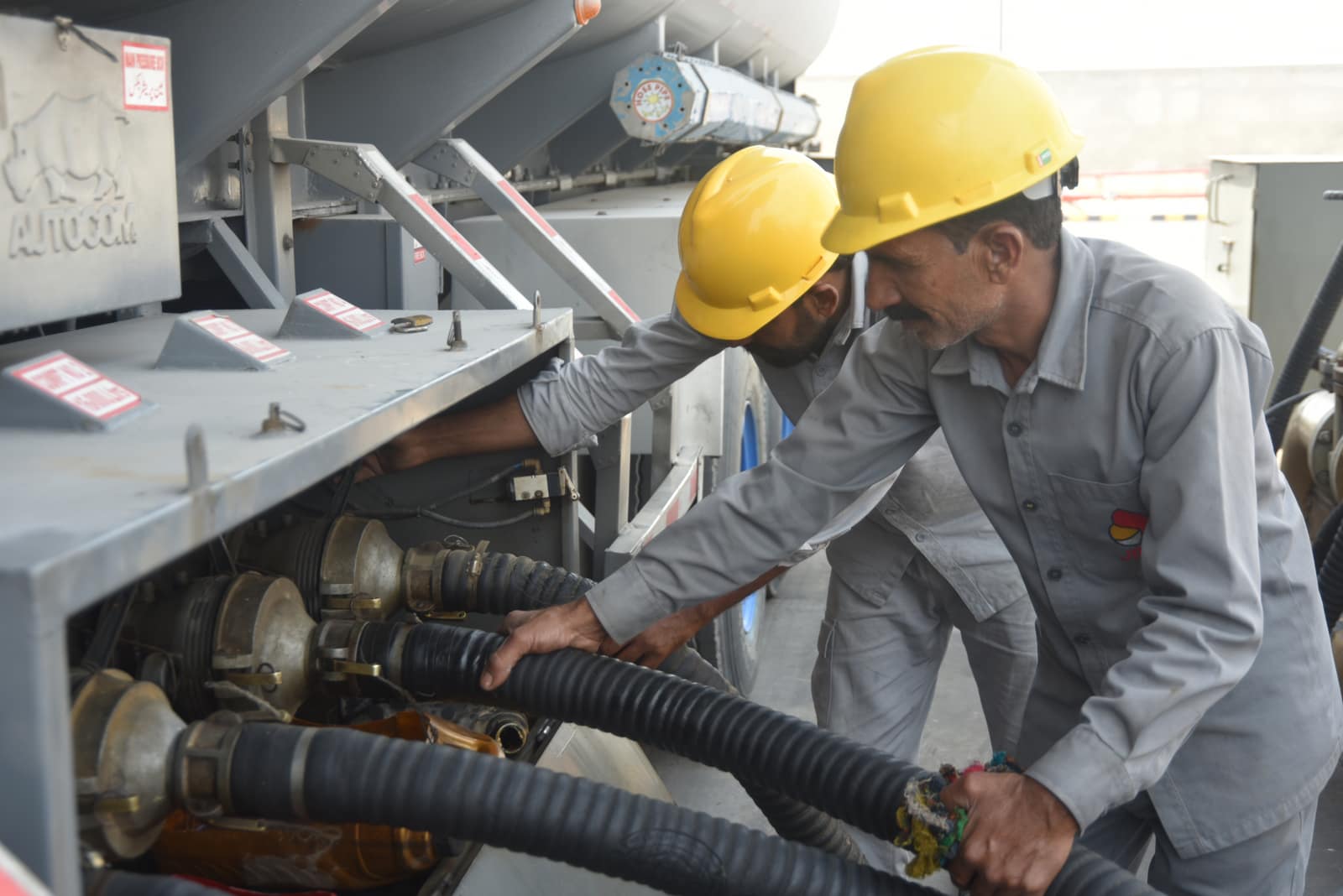 JN Energy team working with fuel hoses at an industrial site